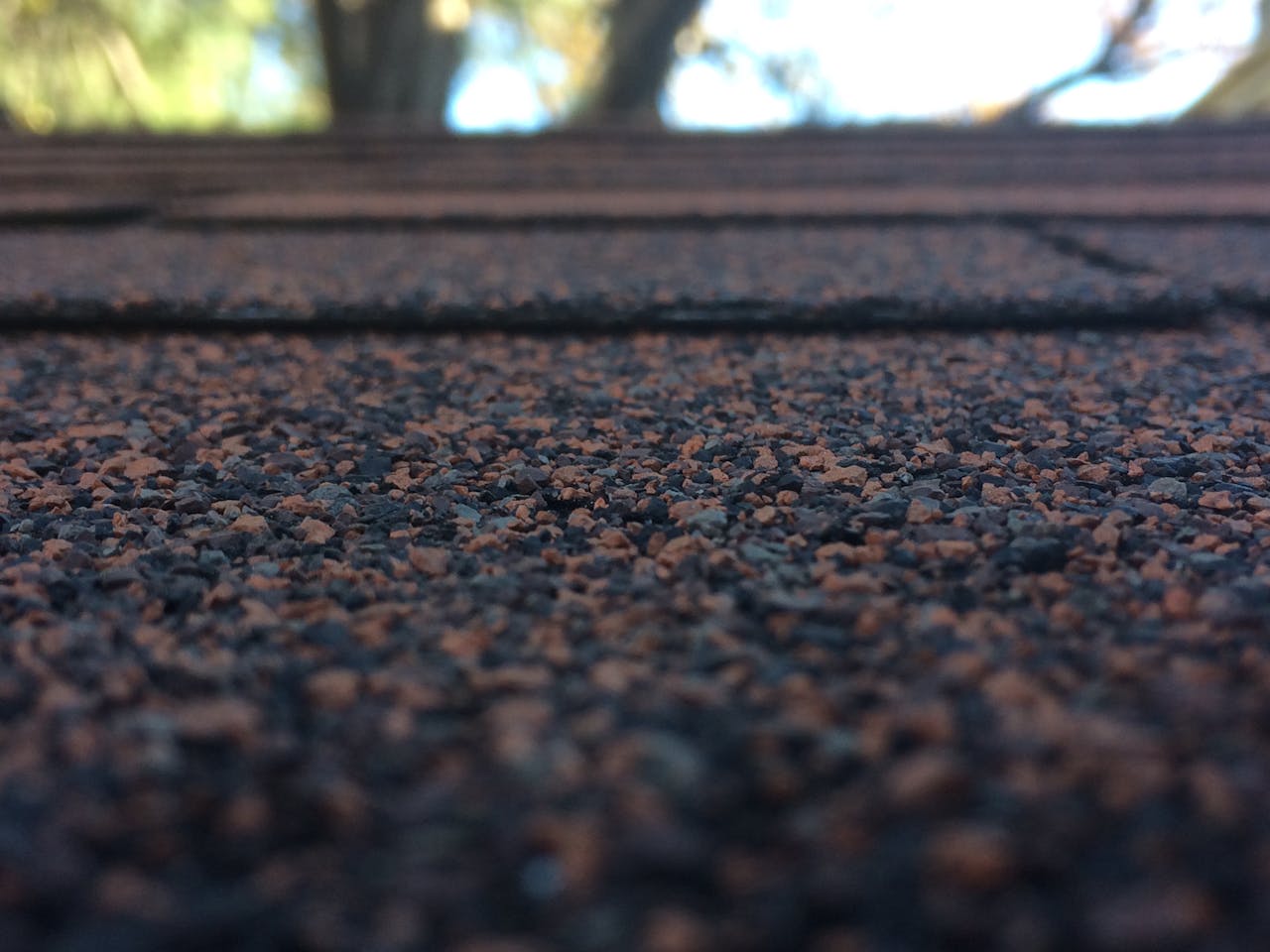 digital Artistic close-up of roof shingles showcasing texture and depth of field with bokeh background.