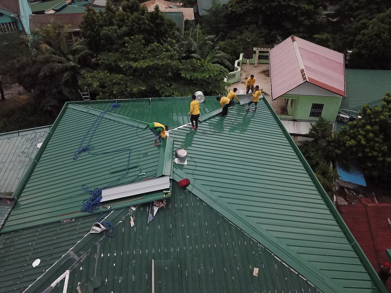 why-choose-us Workers installing green roof panels in Caloocan, Philippines.