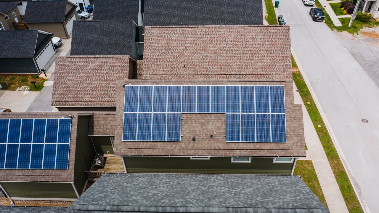 brand-03 Drone shot of solar panels on residential roofs promoting eco-friendly energy solutions.