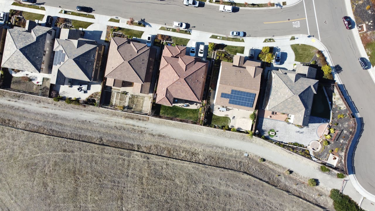 our-story Overhead view of suburban houses with solar panels in Dublin, CA neighborhood.